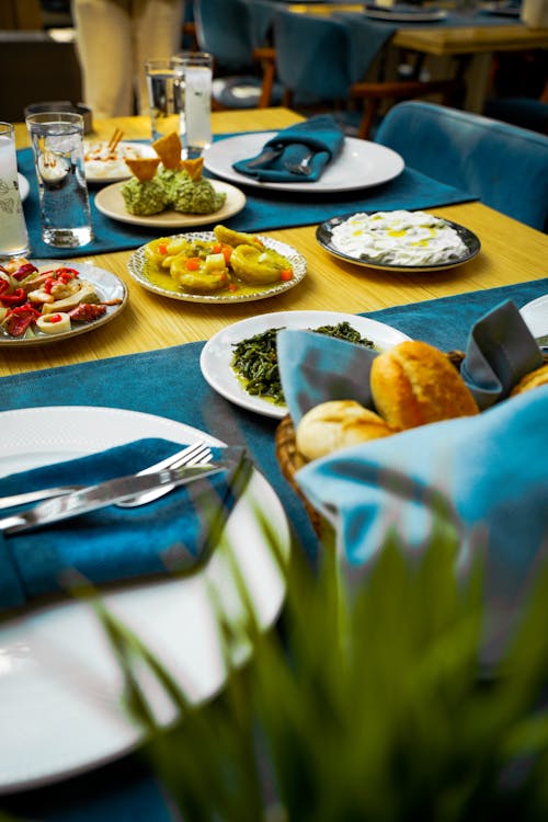 Elegant dining table set with dishes and glassware for guests