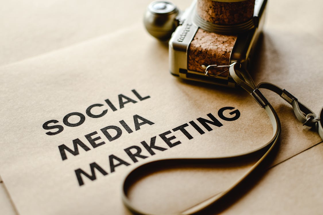 Creative tools and camera on brown paper for content creation