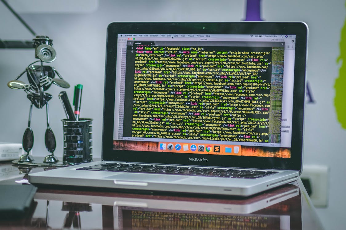 Web development workspace with code on a monitor