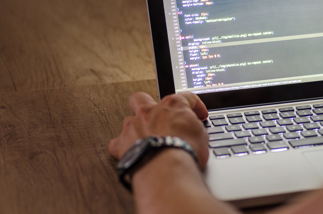 Developer troubleshooting website performance at a monitor